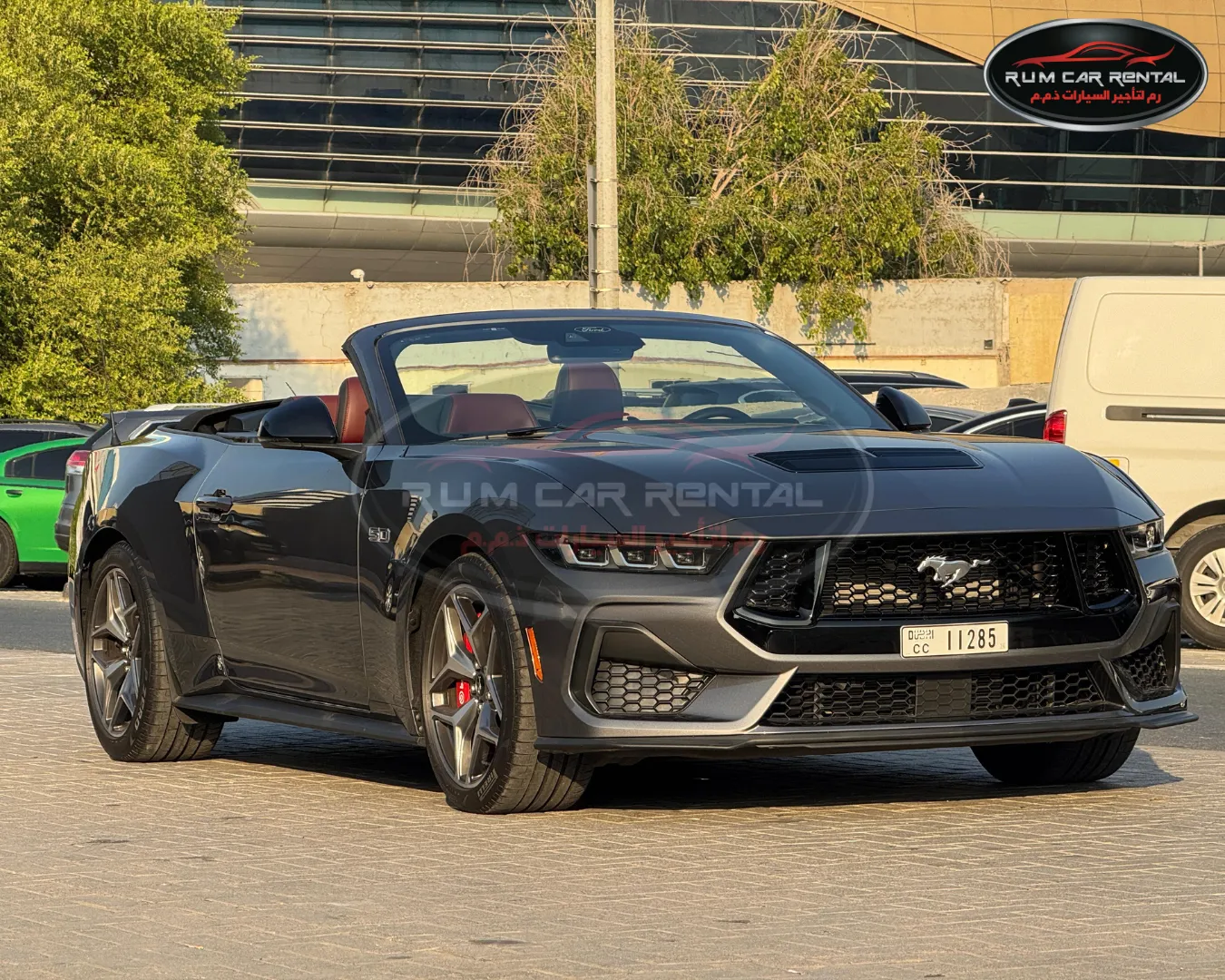 Sleek black Ford Mustang GT convertible rental in Dubai with top down